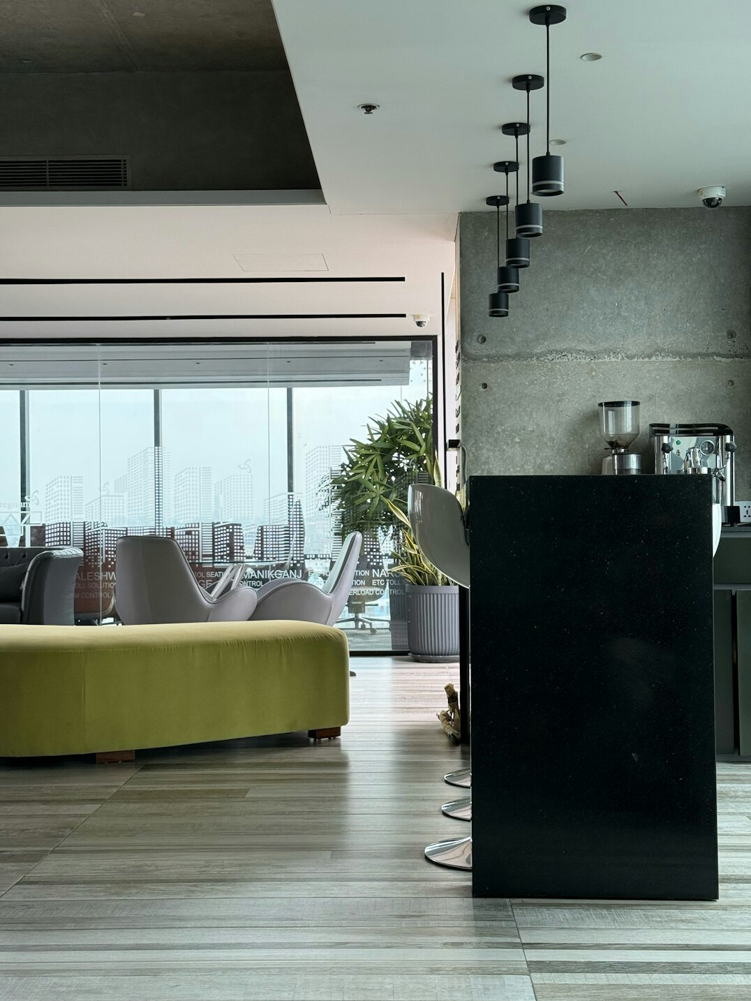 Bright modern open-plan office with large windows and plants