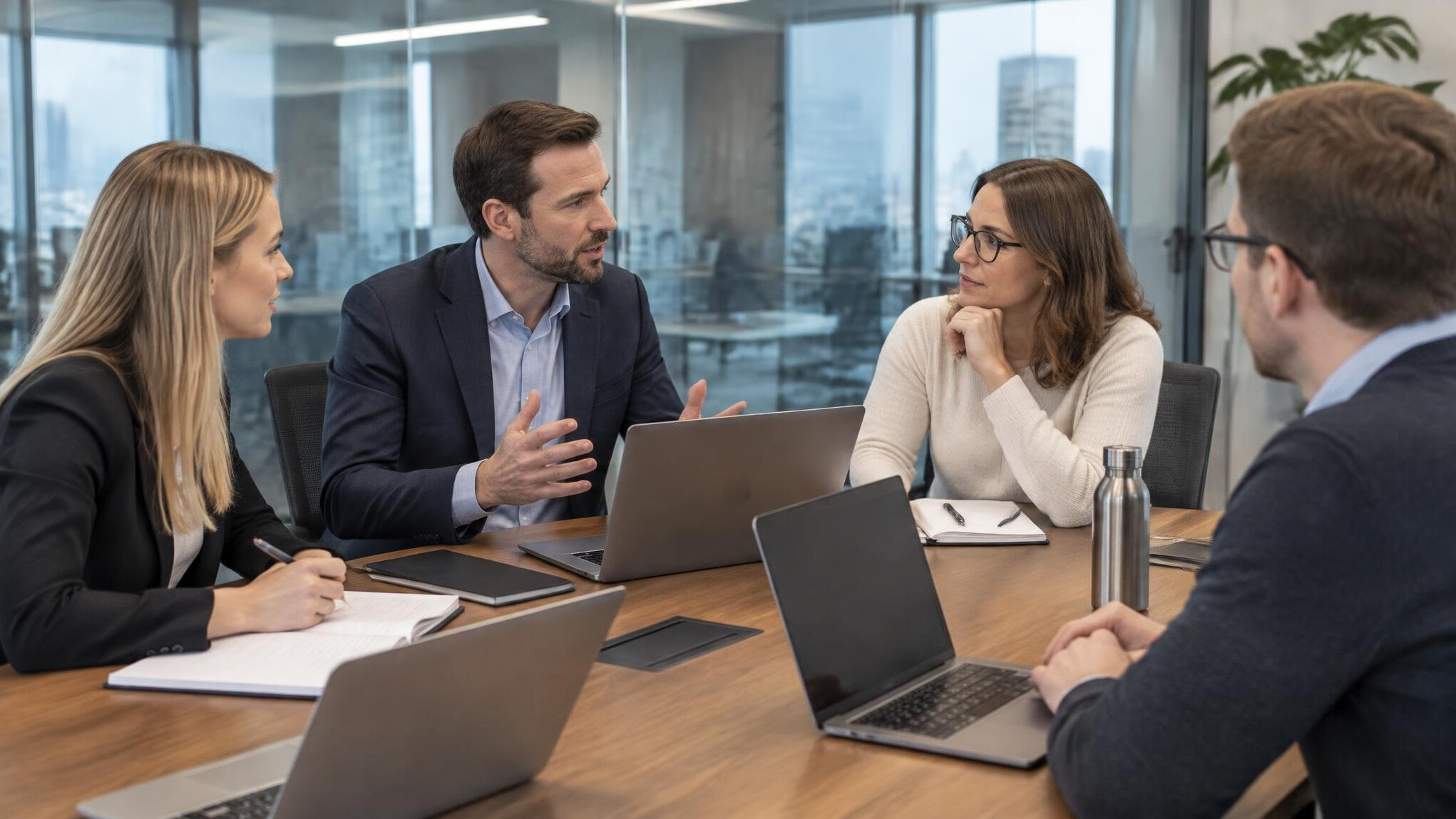 Team sitting in a glass meeting room